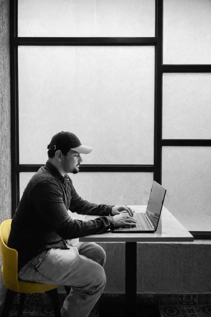 digital marketing strategist in calicut sitting in a yellow chair facing laptop